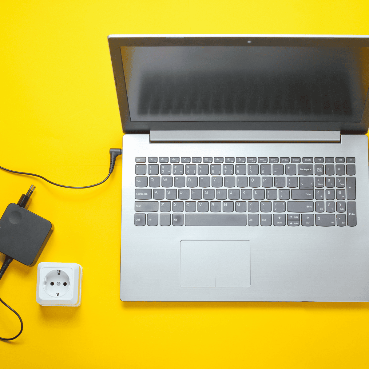 "Black laptop charger with a compact power adapter and a durable cable, featuring a standard plug for wall outlets and a connector for charging laptops efficiently."