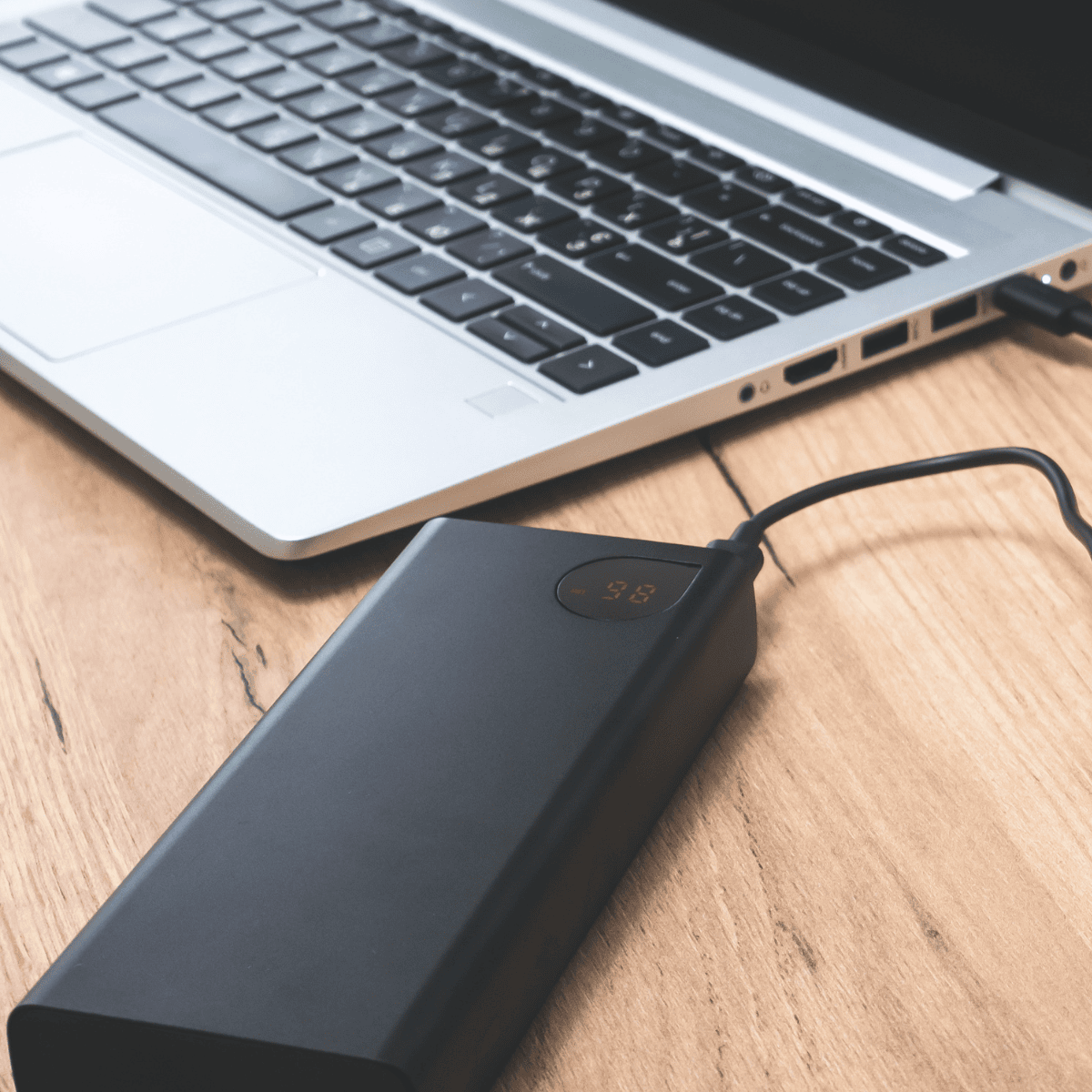 "Compact laptop adapter with a durable power brick and connector cable, designed for efficient and reliable laptop charging."
